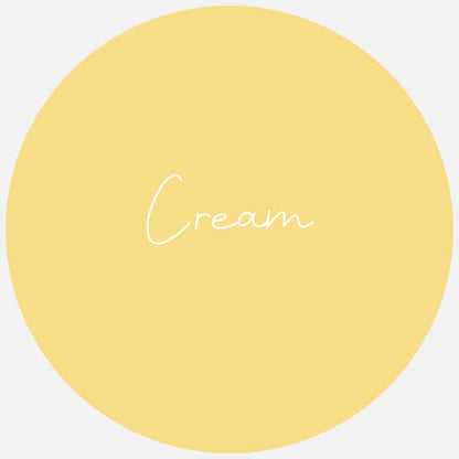 A round sample piece of Avery Dennison GLOSS Permanent Adhesive Vinyl in a yellow color, with the word 'CREAM' written on it.